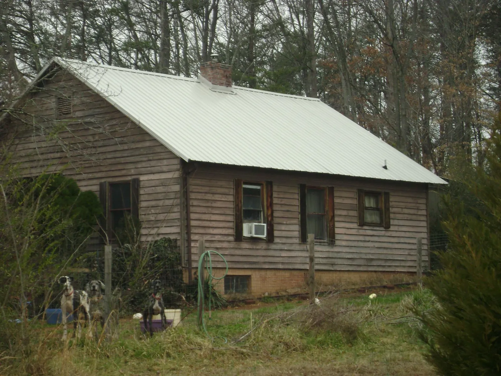 White metal roof on an old wood sided farmhouse, from a Metal Roof Installation job in East Bridgewater